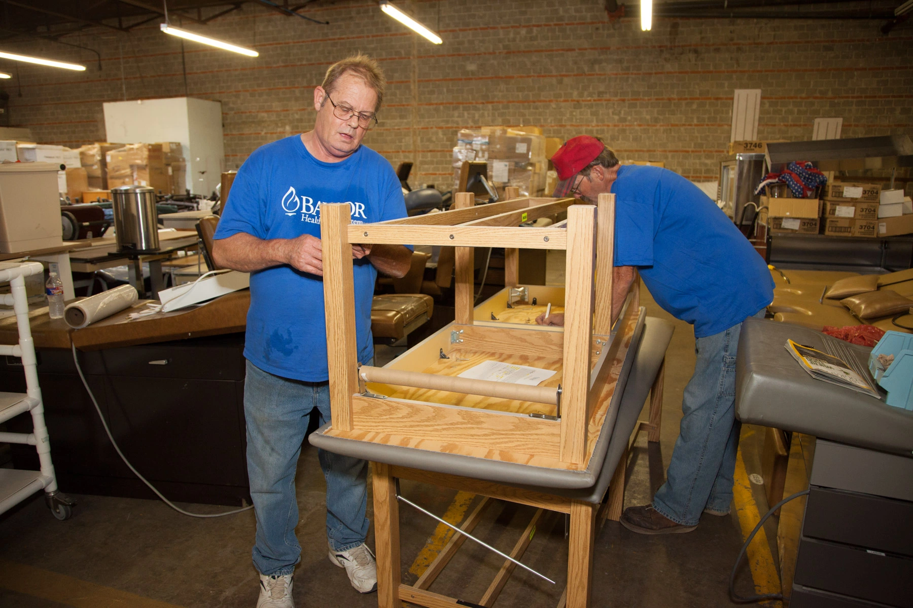 Faith In Action Initiatives volunteers help prepare cargo for shipment