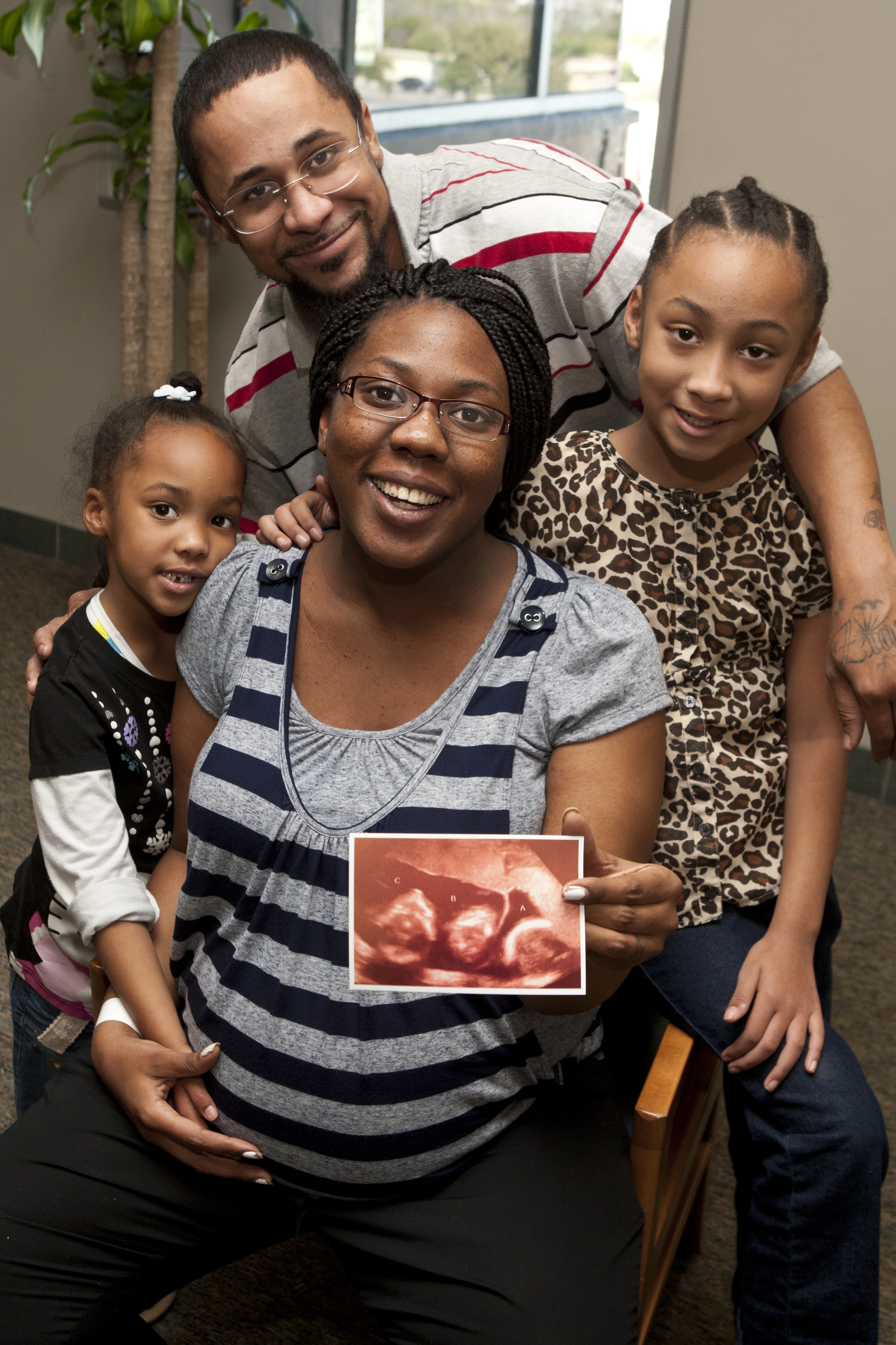 Lynch family showing sonogram of rare triplets