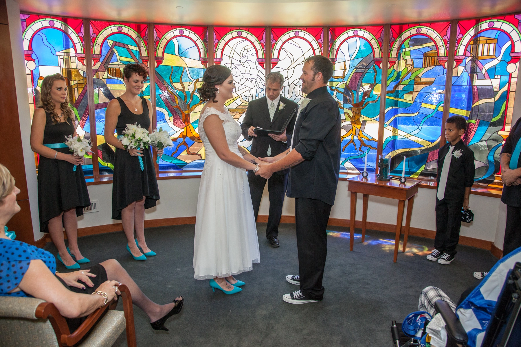 bride and groom hold hands