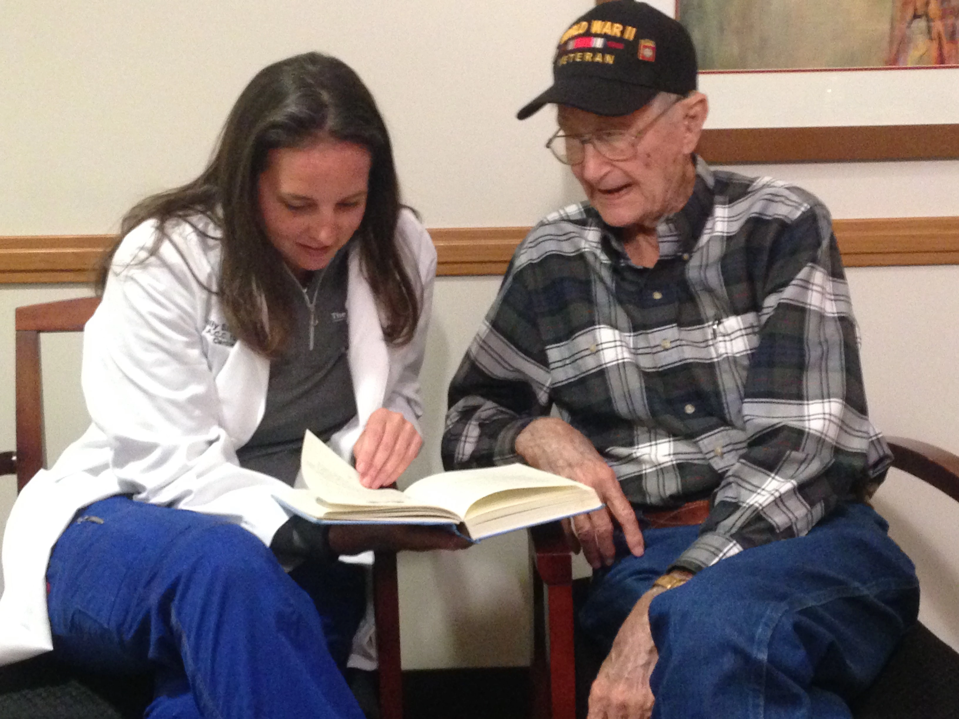 Dr. Szerlip looking at WWII book with Mr. Harris